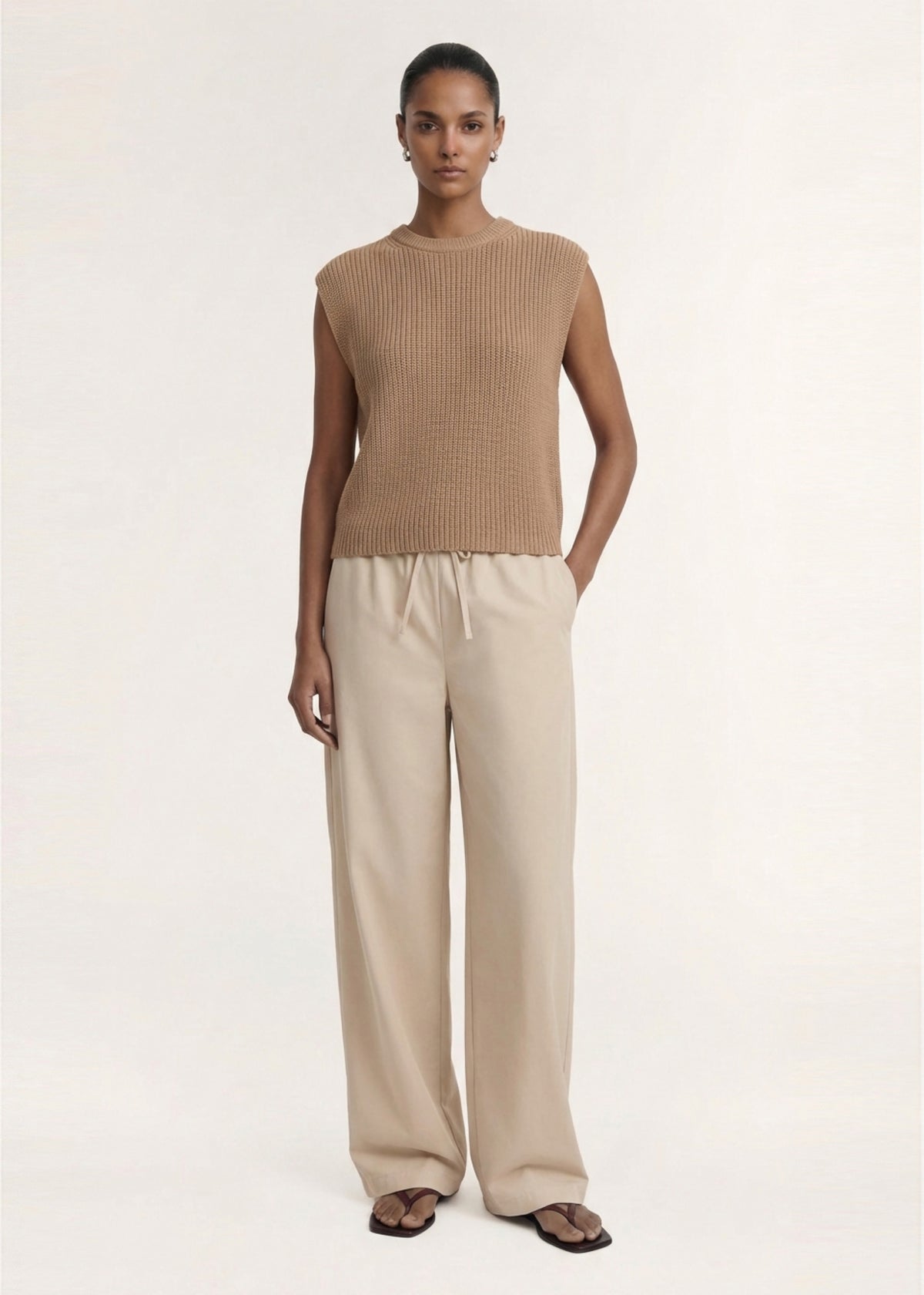 Model wearing Taupe Cotton Blend Knit Tank Top, showing an easy layering essential and a designed.