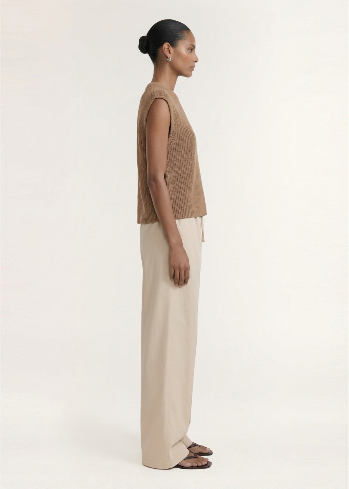 Side view of the Taupe Cotton Blend Knit Tank Top, showing a textured rib knit fabrication and a sleeveless silhouette.