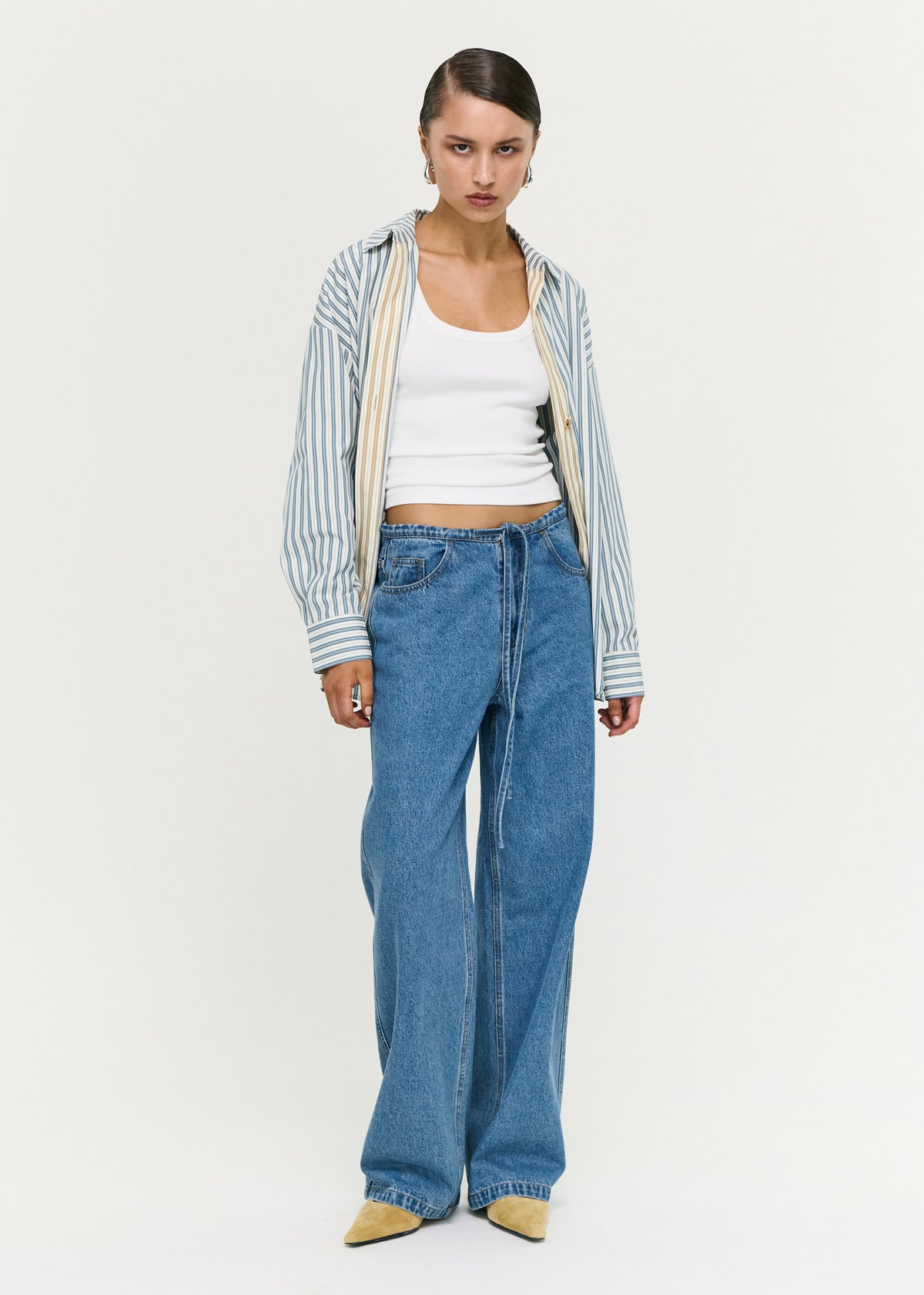 Model wearing Tie Waist Detail Mid Rise Jeans, showing a relaxed straight-leg silhouette and a full-length design.