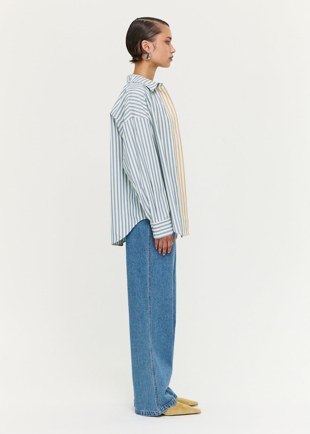 Side view of the Tie Waist Detail Mid Rise Jeans, showing a curved seam detailing and an adjustable waist tie detail.