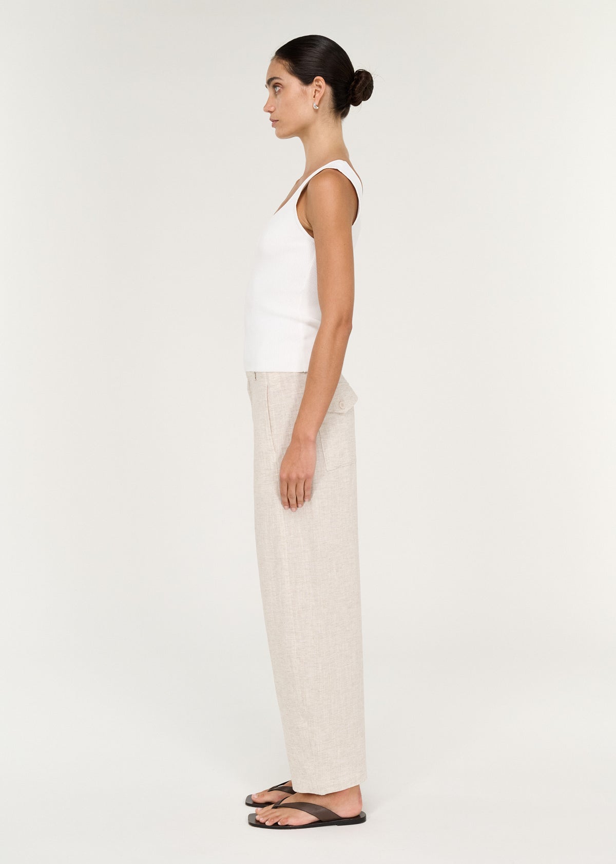 Side view of the Viscose Linen Barrel Leg Pant in Oat, showing belt loops and a front fly closure.