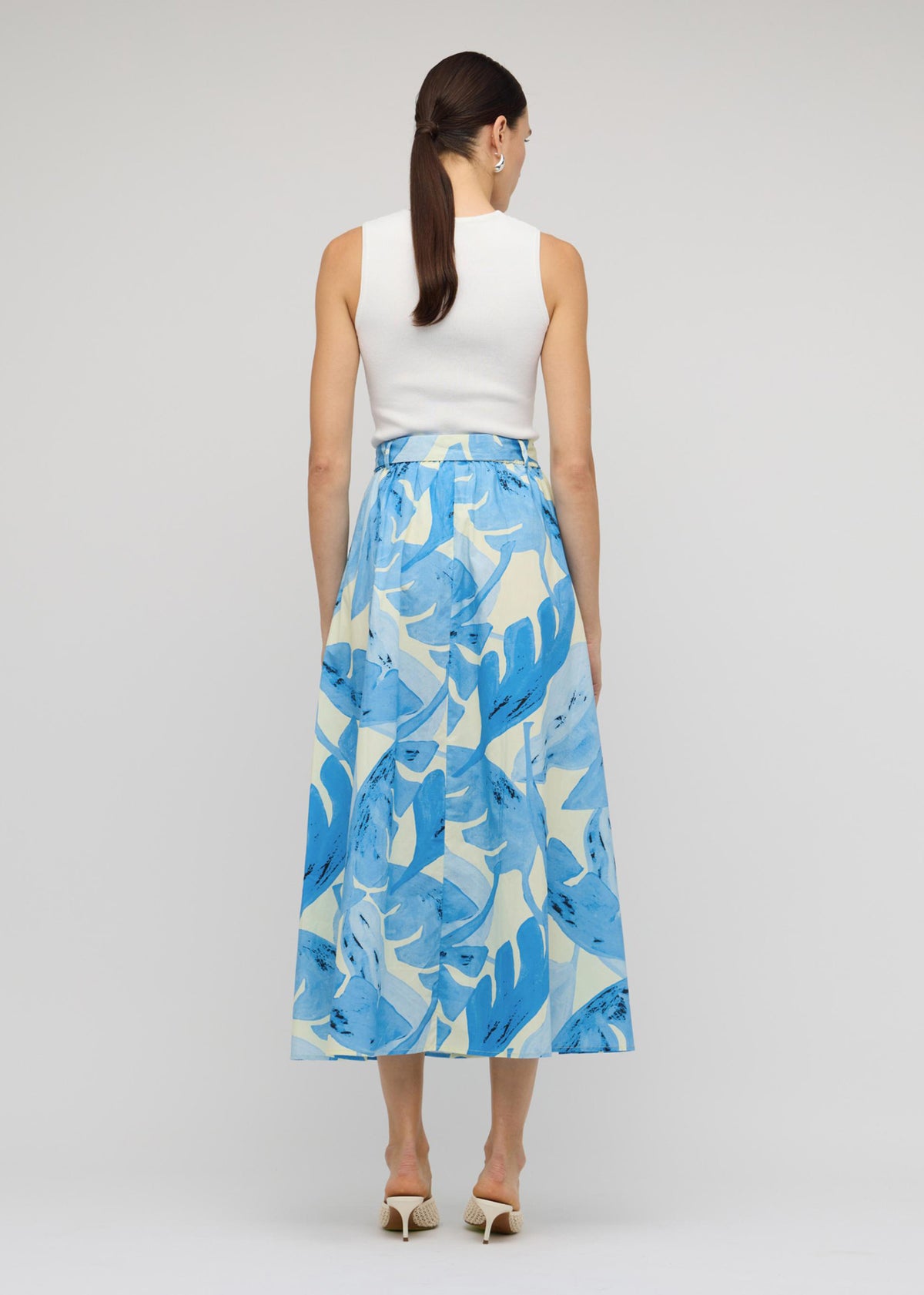 Back view of the White Cut-Out Sleeveless Knit Top with a sleeveless cut and a ribbed stretch fabrication.