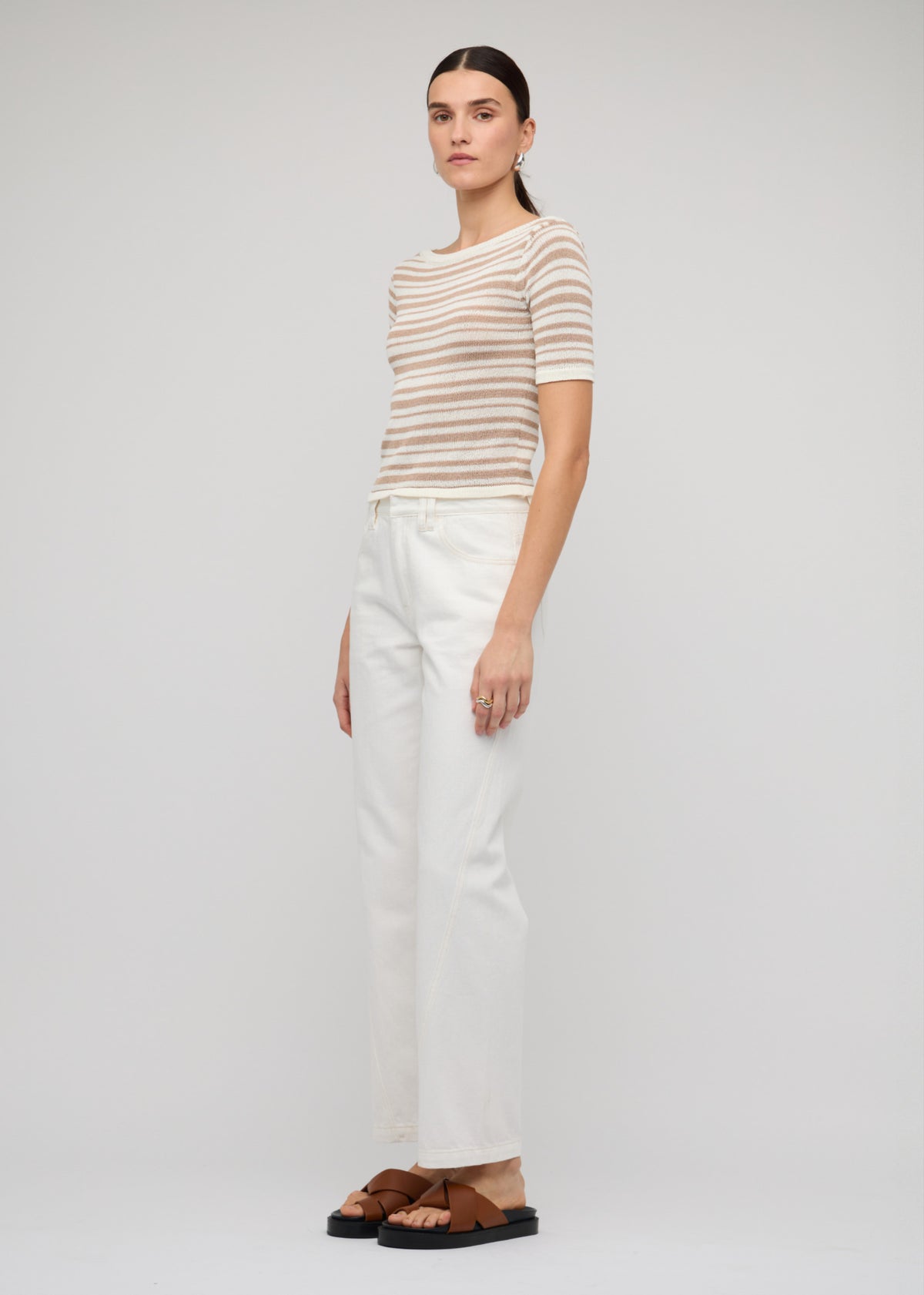 Model wearing White Denim Mid-Rise Straight Jeans with a mid-rise waist and an off-white wash.