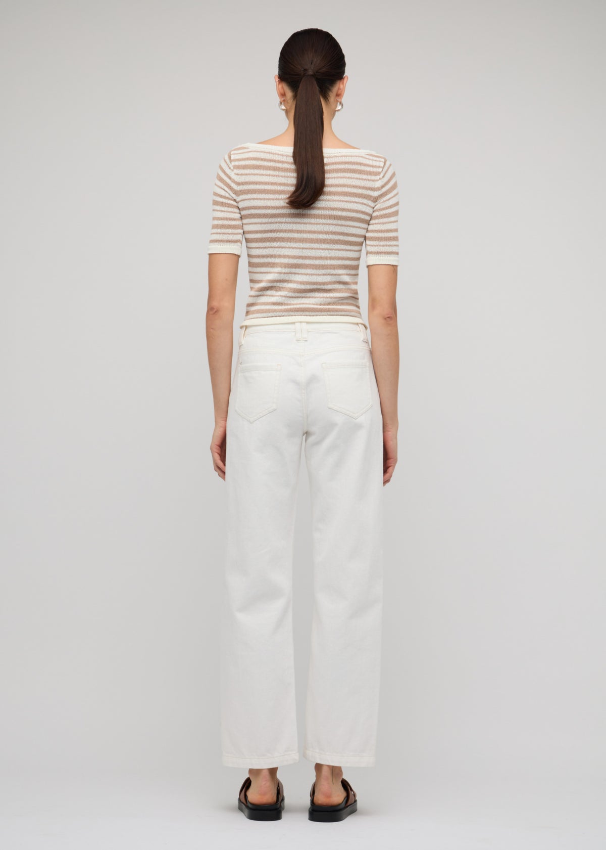 Back view of the White Denim Mid-Rise Straight Jeans, showing a button and zip fly closure.