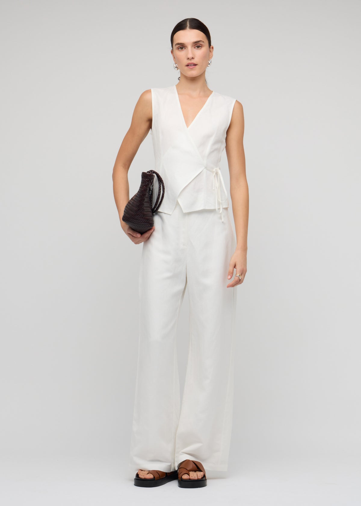 Model wearing White Linen Wide Leg Pants, showing a wide-leg silhouette and side pockets.