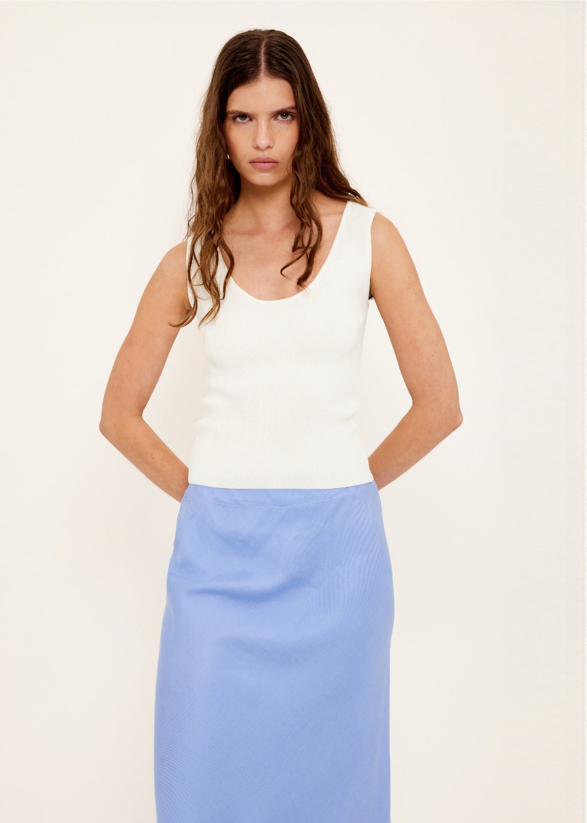 Close-up of the White Reversible Knit Tank Top, showing a reversible design: wear and a fitted rib knit silhouette.