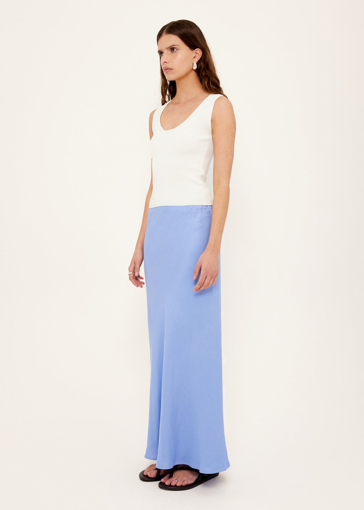 Model wearing White Reversible Knit Tank Top with a lightweight, stretchy fabric and a reversible design: wear.