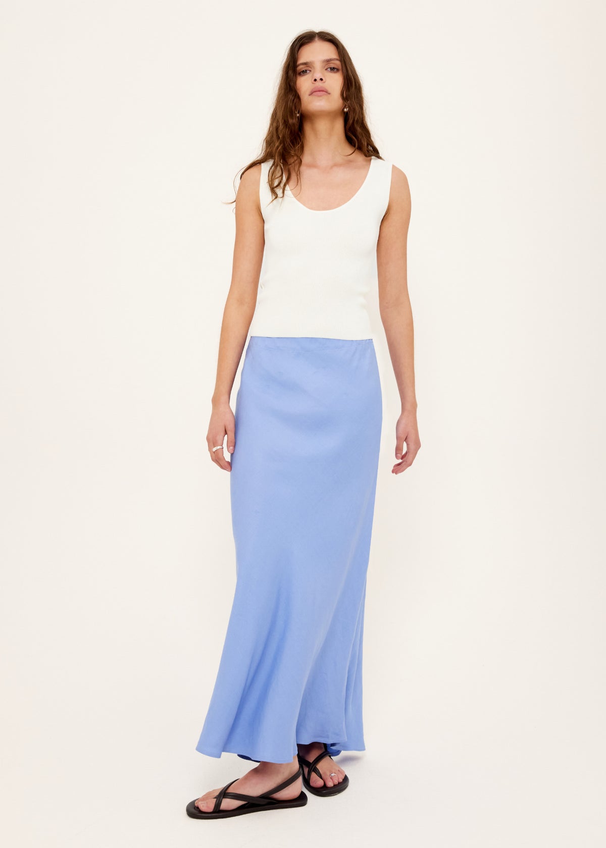 Model wearing White Reversible Knit Tank Top with a reversible design: wear and a fitted rib knit silhouette.