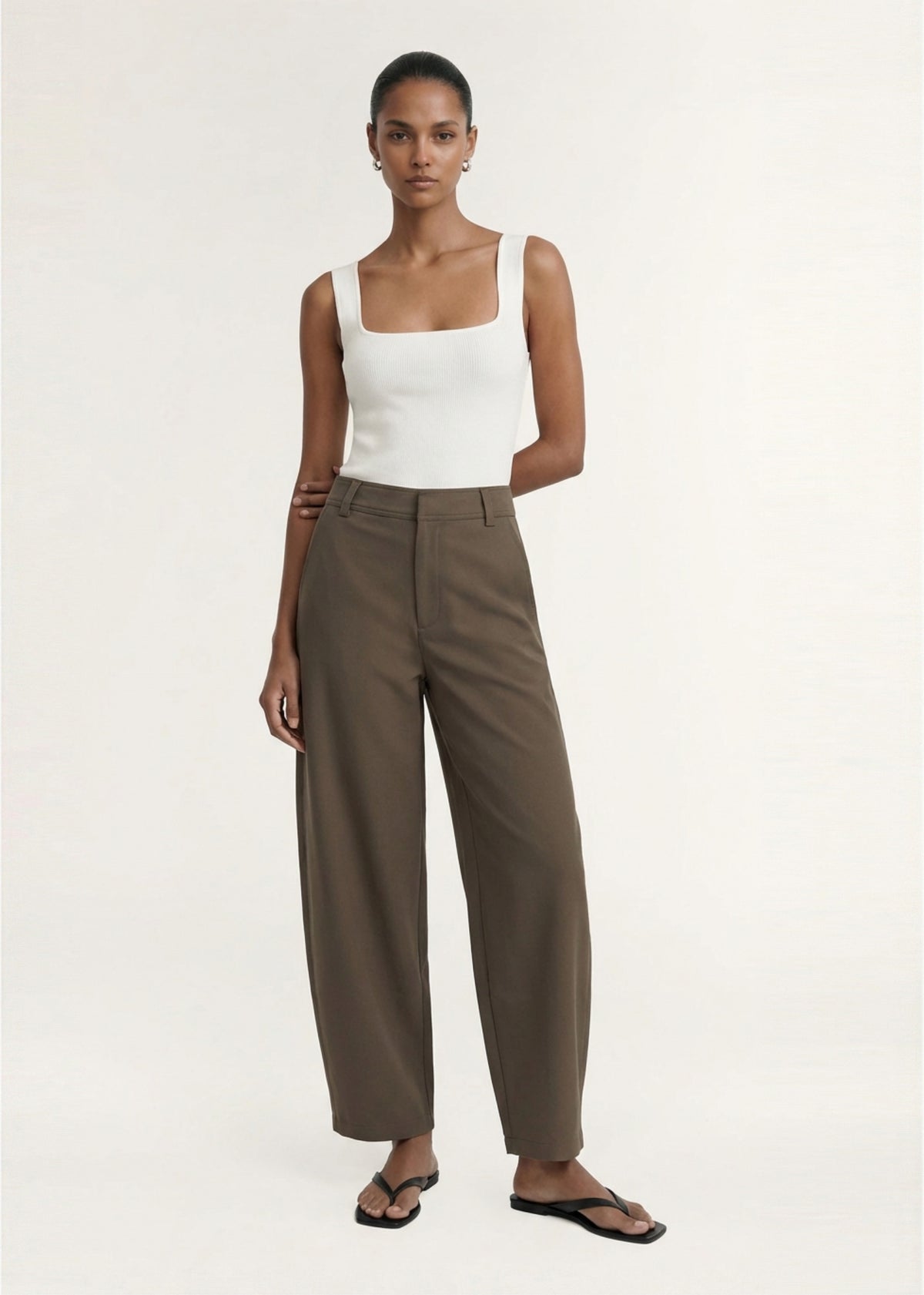 Model wearing White Square Neck Ribbed Knit Tank with a ribbed knit fabrication and a square neckline.
