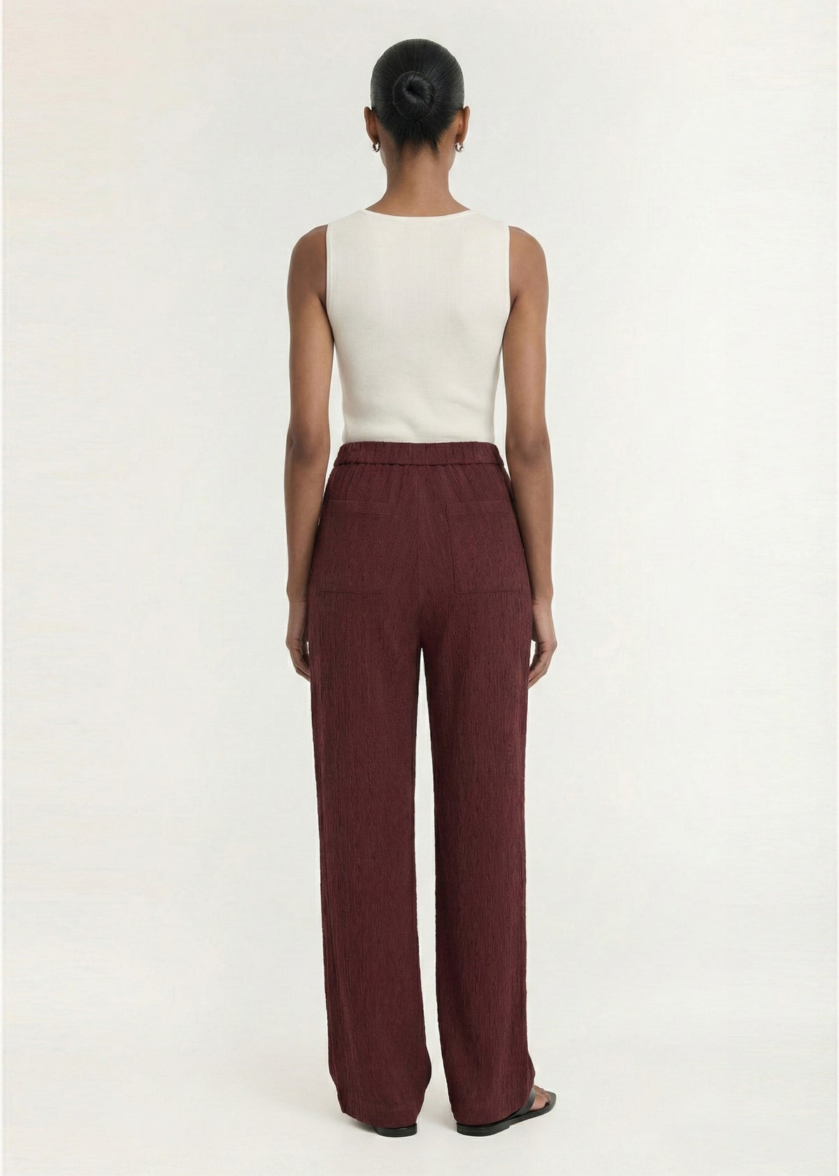 Back view of the White Square Neck Ribbed Knit Tank, showing wide shoulder straps and a ribbed knit fabrication.