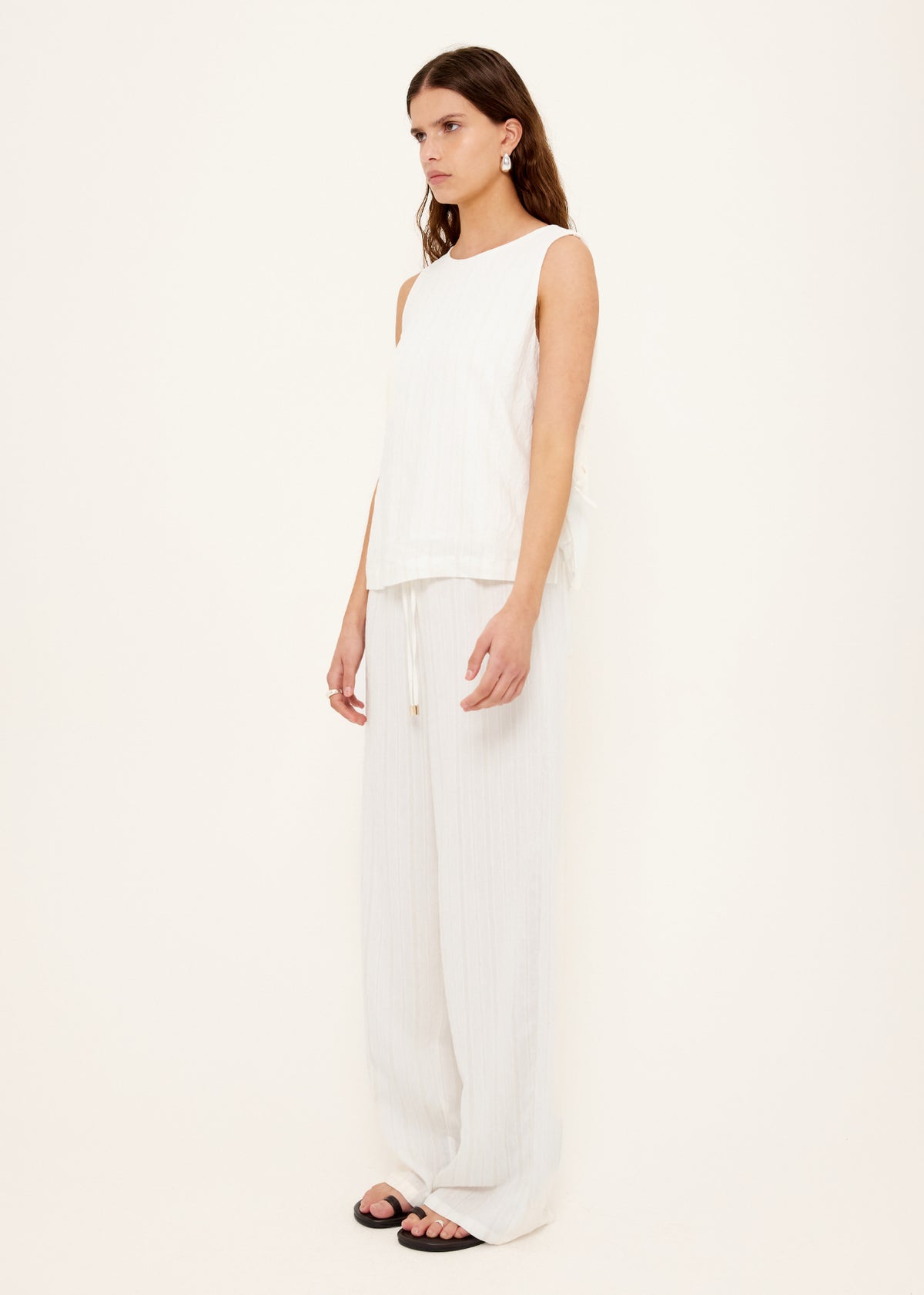 Model wearing White Tie-Side Top with a functional side tie detailing and a fully lined.