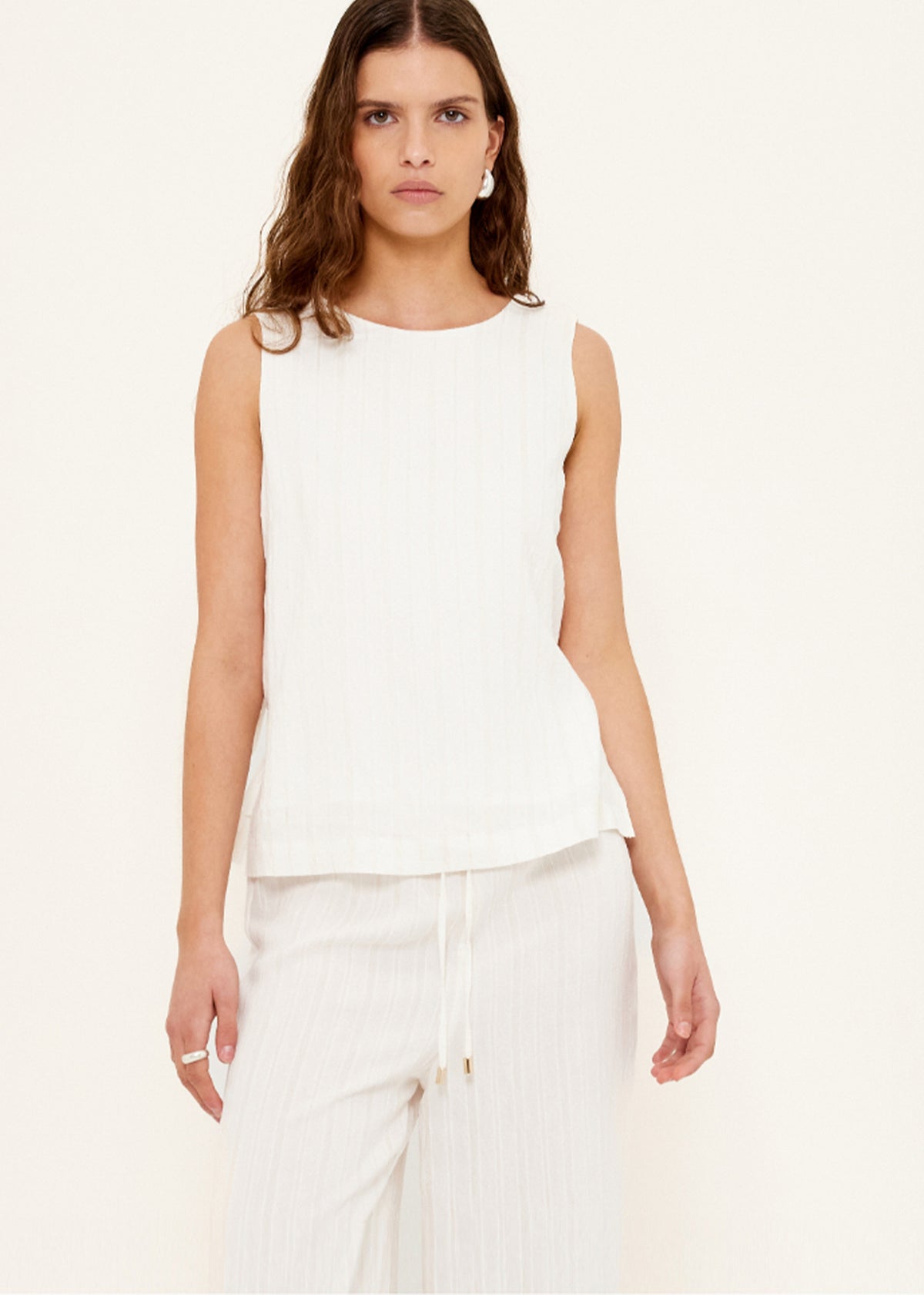 Close-up of the White Wide Leg Drawstring Pants, showing an elasticated waistband with drawstring tie and a relaxed wide-leg silhouette.