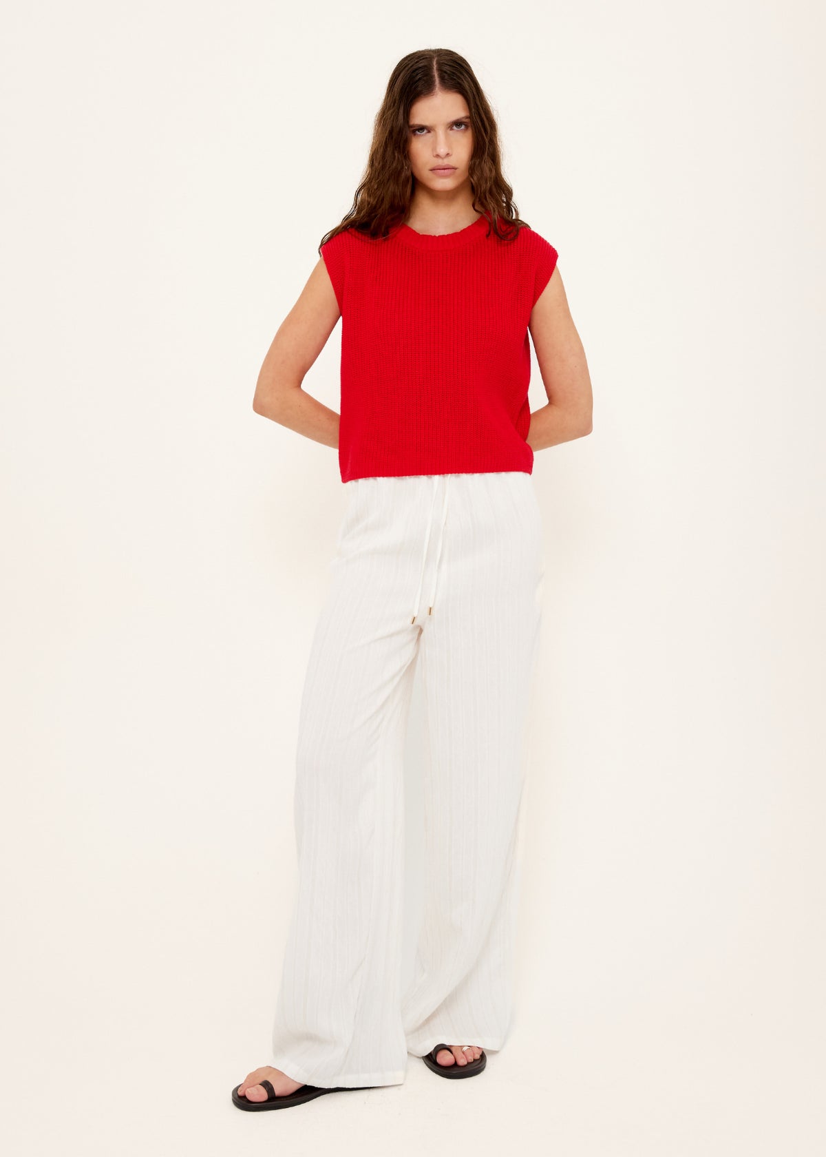 Model wearing White Wide Leg Drawstring Pants, showing a lightweight textured fabrication and a full length.